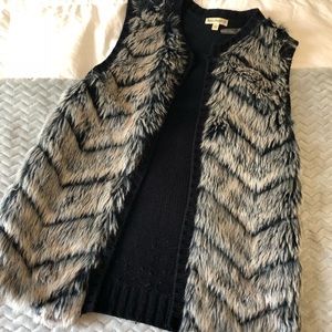 Grey and black faux fur vest.